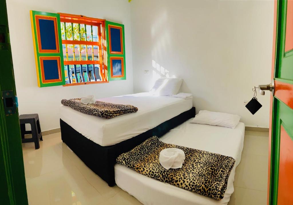 Postel nebo postele na pokoji v ubytování casa hostal las palmeras