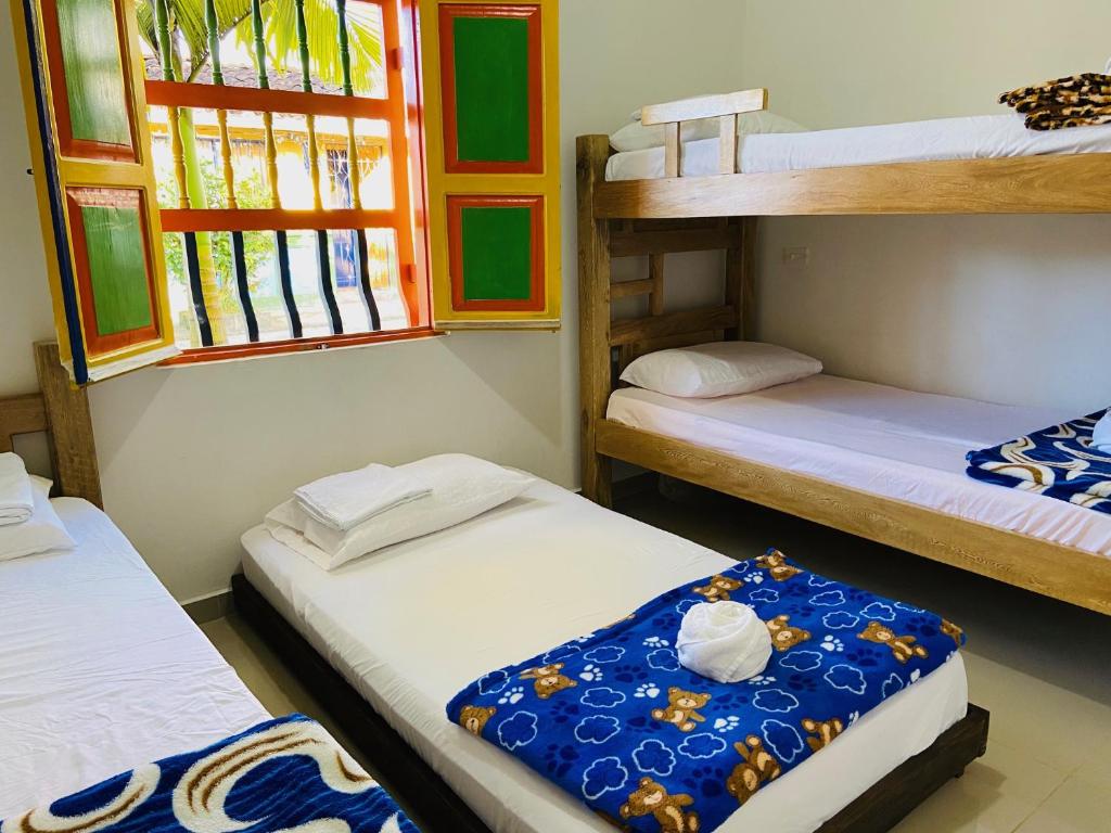 Postel nebo postele na pokoji v ubytování casa hostal las palmeras