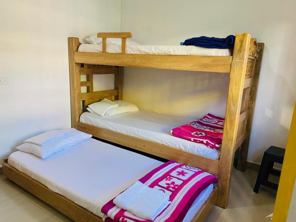 Postel nebo postele na pokoji v ubytování casa hostal las palmeras