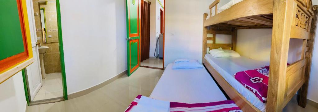 Postel nebo postele na pokoji v ubytování casa hostal las palmeras