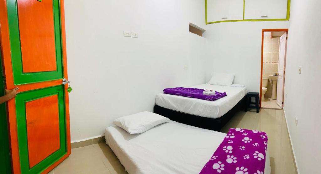 Postel nebo postele na pokoji v ubytování casa hostal las palmeras