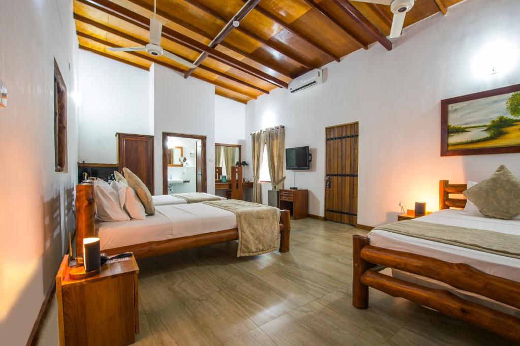 Postel nebo postele na pokoji v ubytování Kalu's Hideaway Udawalawe