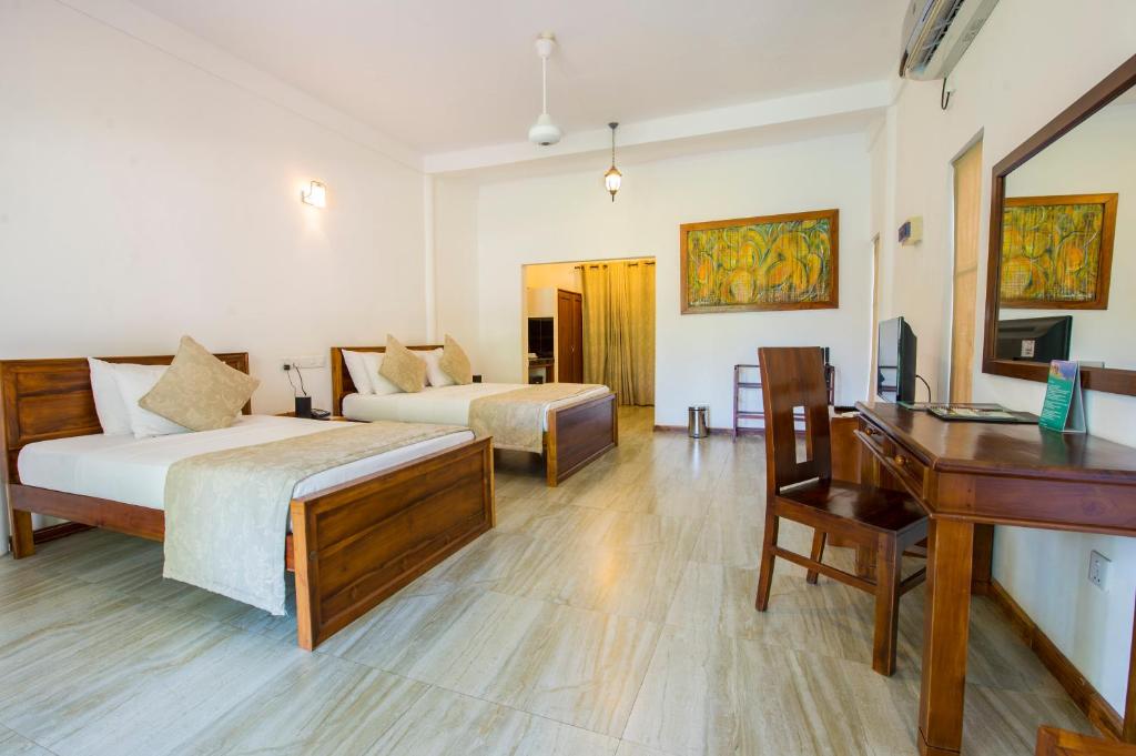 Postel nebo postele na pokoji v ubytování Kalu's Hideaway Udawalawe