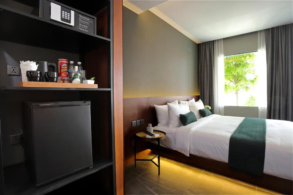 Postel nebo postele na pokoji v ubytování Baitong Hotel & Resort Phnom Penh