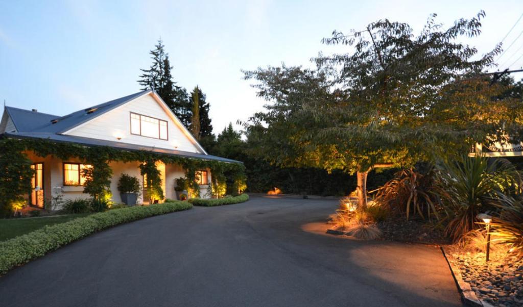 a driveway leading to a house with a tree at Olive Rabbit - Boutique Bed & Breakfast in Turangi