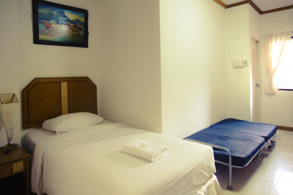 Postel nebo postele na pokoji v ubytování The Residence Hotel -SHA Extra Plus