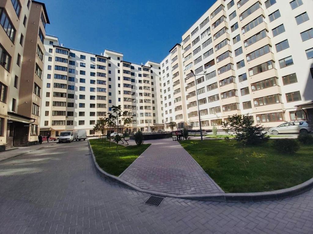 ein großes Apartmenthaus mit einem Park davor in der Unterkunft Apartament, sectorul Buiucani in Chişinău