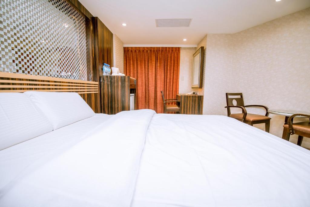 Postel nebo postele na pokoji v ubytování Guide Hotel Taipei Xinyi