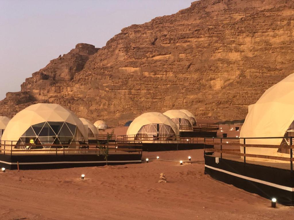 
a number of tents in a desert area at Sharah Luxury Camp in Wadi Rum
