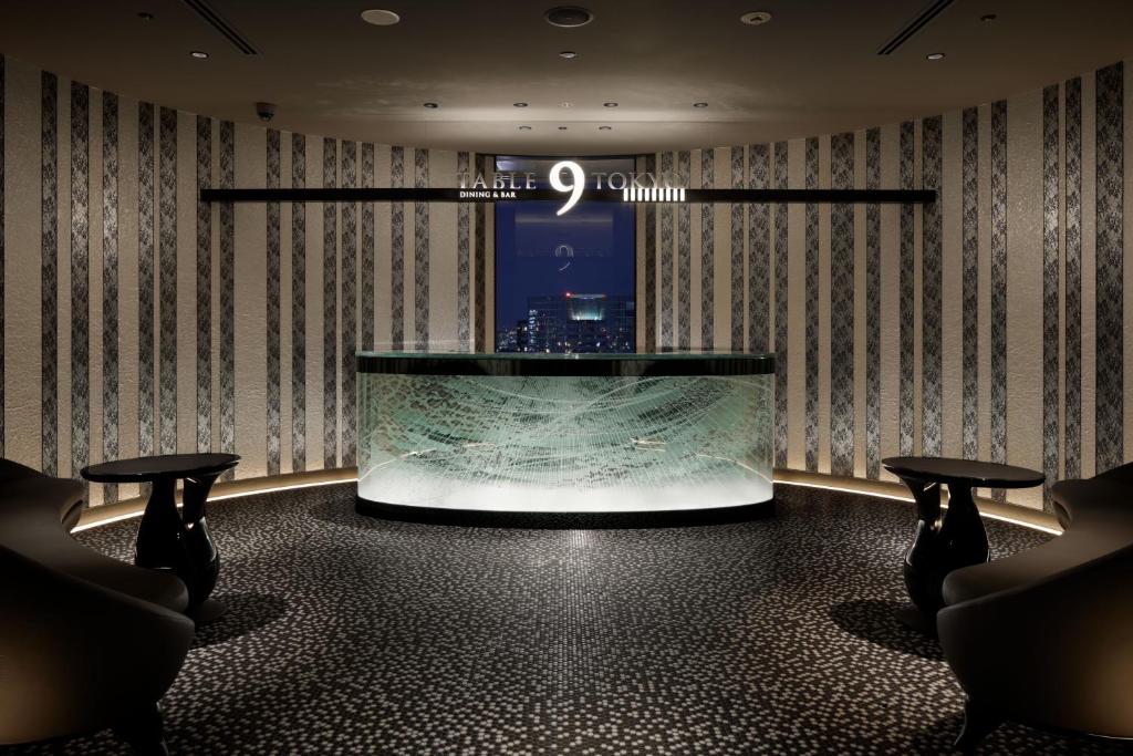 a lobby with a large aquarium in the middle of a room at Shinagawa Prince Hotel N Tower in Tokyo