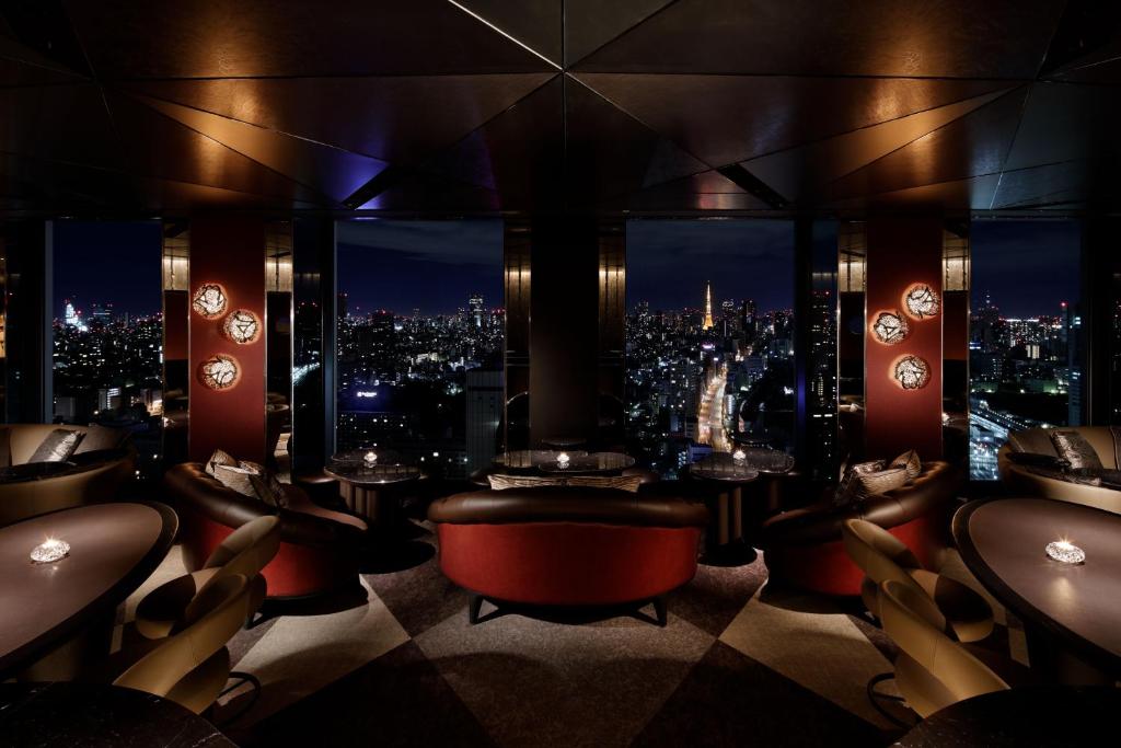 a bar with a view of a city at night at Shinagawa Prince Hotel N Tower in Tokyo