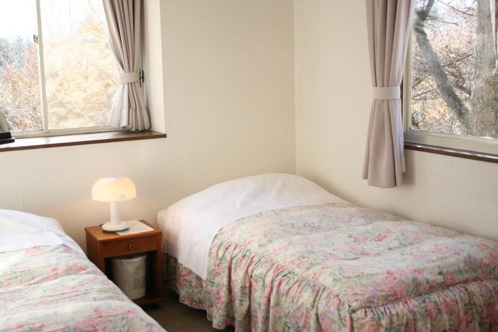 Llit o llits en una habitació de Pension Asahi