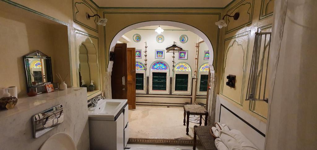 a large bathroom with a sink and a mirror at Jaipur Haveli in Jaipur