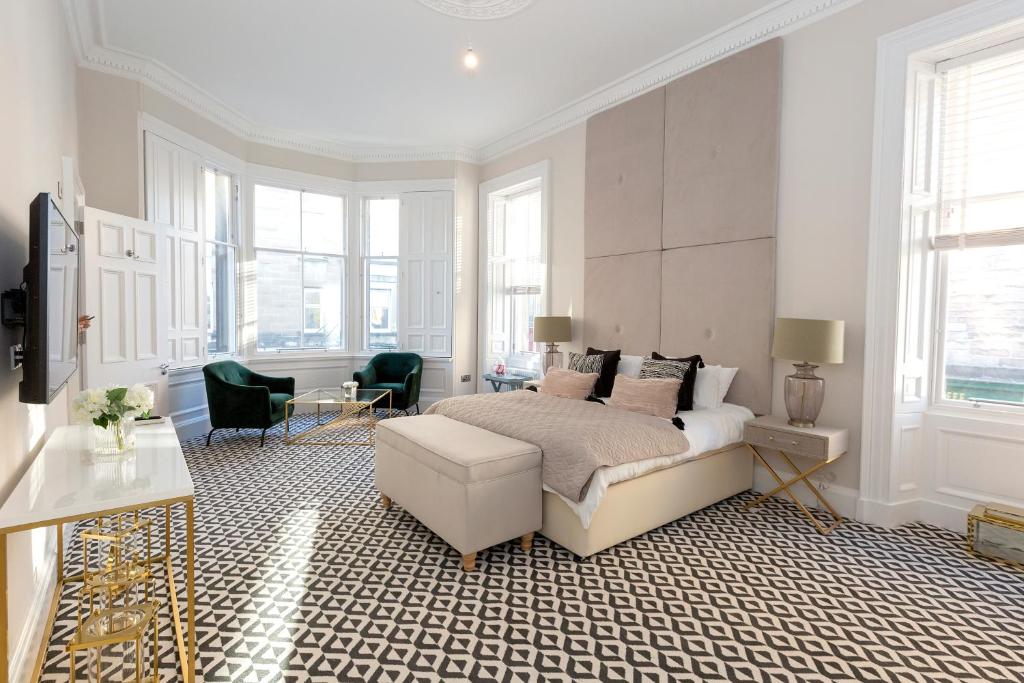 a bedroom with a bed and a desk and chairs at The Lane Hotel in Edinburgh