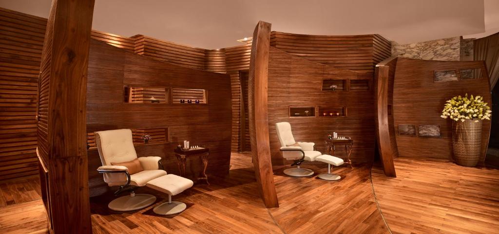 a salon with two chairs and a mirror at The Reverie Saigon in Ho Chi Minh City