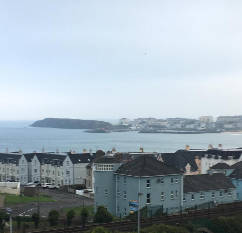 a view of a city with houses and the water at The Carrick in Portrush