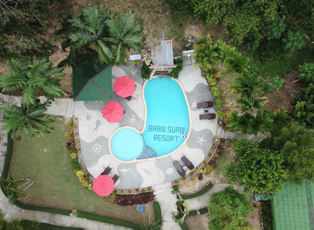 an overhead view of a swimming pool with pink umbrellas at Ao Nang Baan Suan Resort in Ao Nang Beach