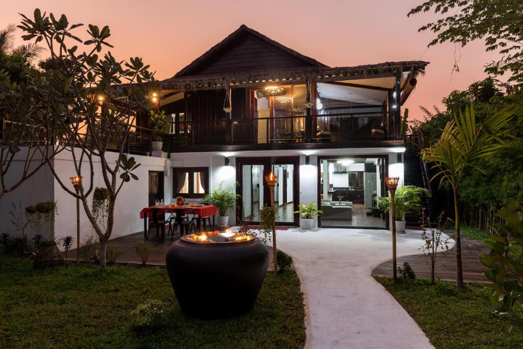 a house with a walkway in front of it at Sampeah Retreat Villa in Siem Reap