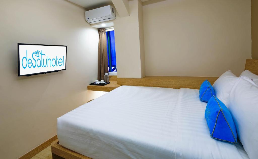 Postel nebo postele na pokoji v ubytování Desatu Hotel