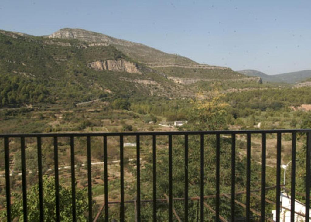 a view from a balcony overlooking a mountain range at La Piedra del Mediodía in Cirat