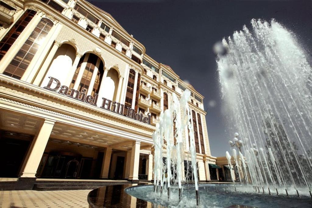 a water fountain in front of a building at Daniel Hill Hotel in Tashkent