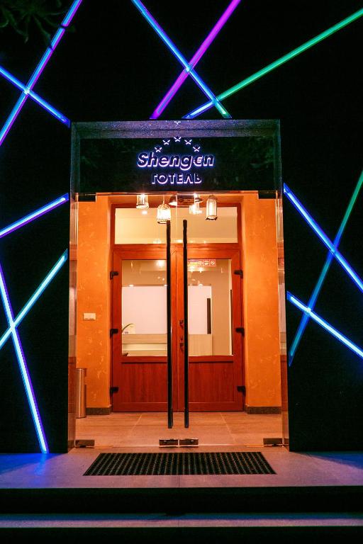a doorway into a room with blue and purple lights at Hotel Shengen "Шенген" in Kropyvnytskyi