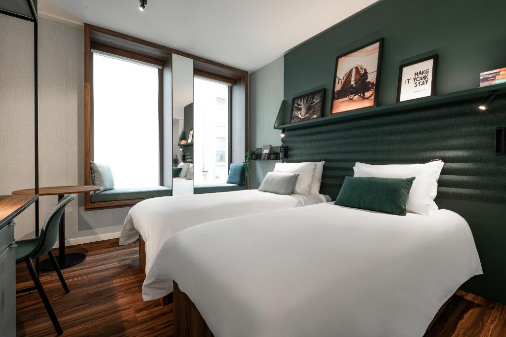 a bedroom with a large bed and a large window at A-STAY Antwerp in Antwerp