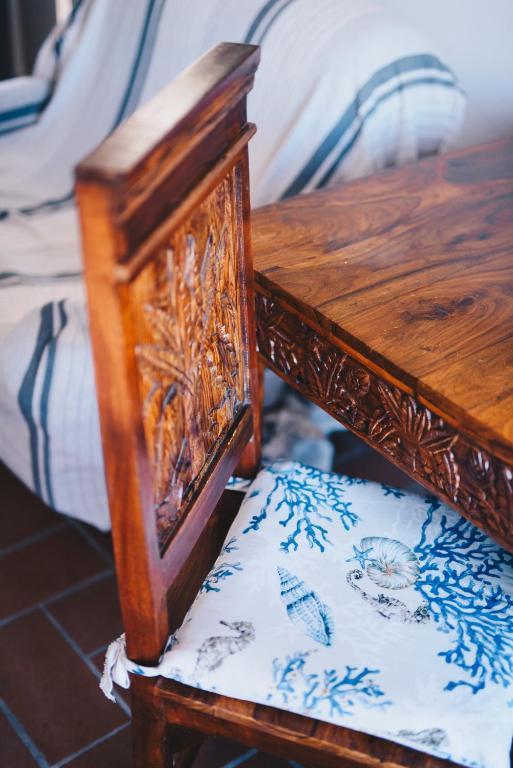 a wooden bench with a wooden table and a seat at La Torretta in Lerici