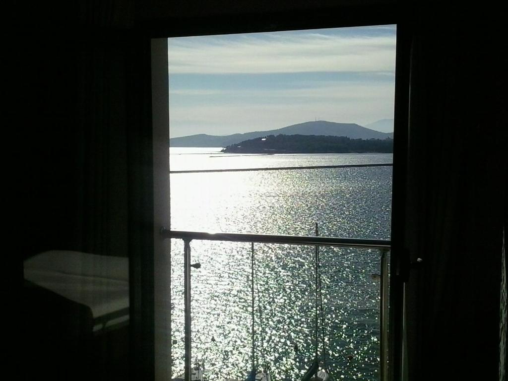 una ventana con vistas al agua en Hotel Kipseli, en Volos