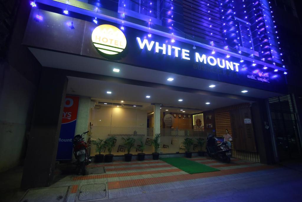 a building with a white mountain sign on it at Hotel White Mount in Chennai