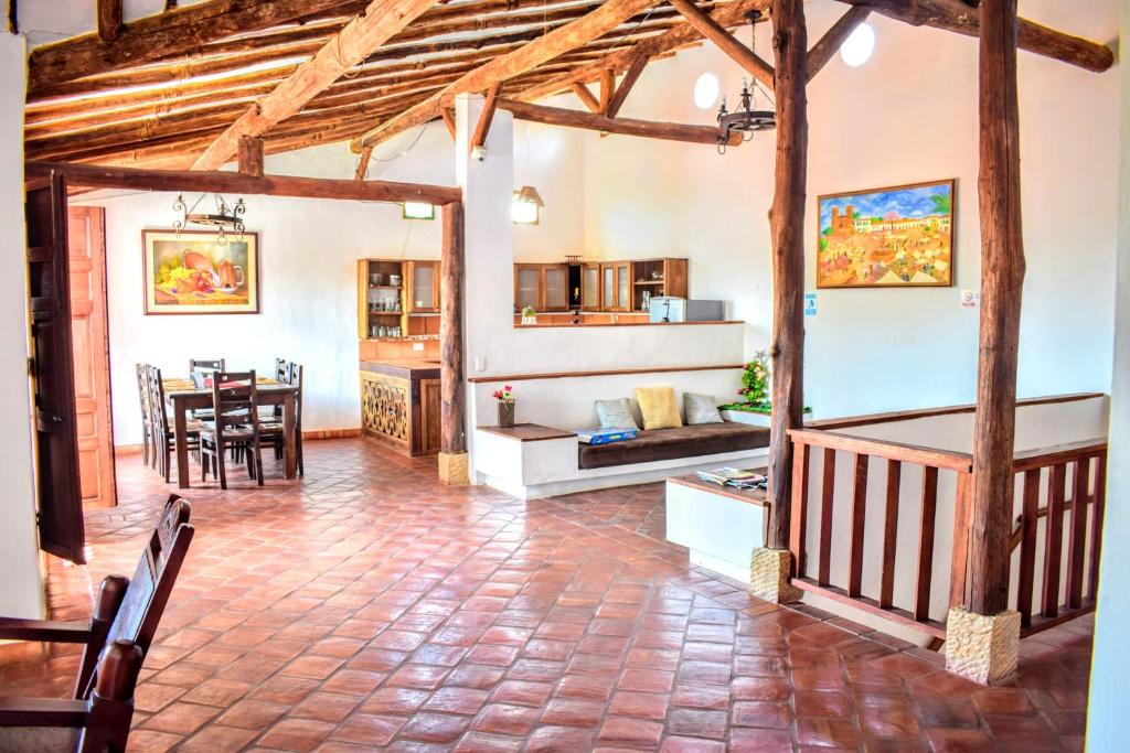 a living room with a table and a dining room at El Zaguan in Barichara