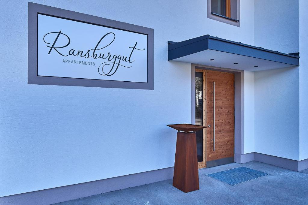 a white wall with a sign for a restaurant at Appartment Ransburggut in Flachau