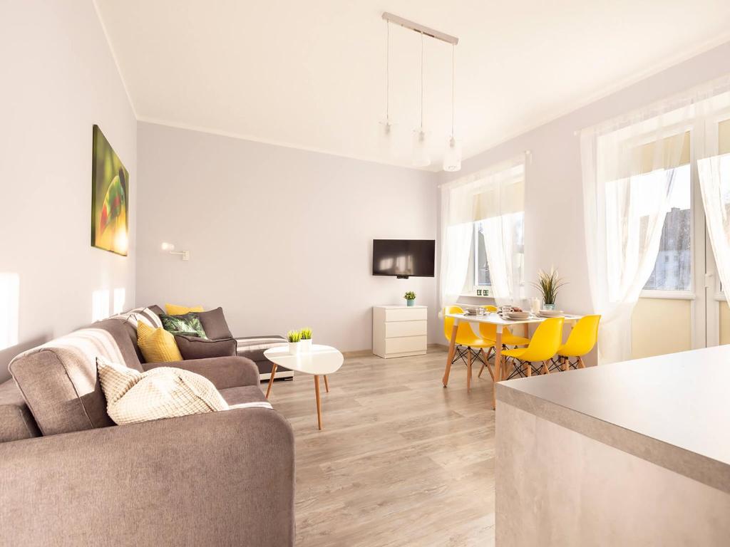 a living room with a couch and a table at VacationClub – Poleska 4C Apartament 7 in Kołobrzeg