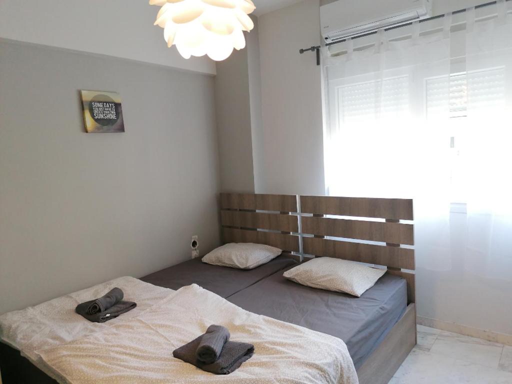 a bedroom with two beds with hats on them at Aristotelous 1 min supercentral Mini studio- renewed with brand new professional orthopedic mattresses in Thessaloniki
