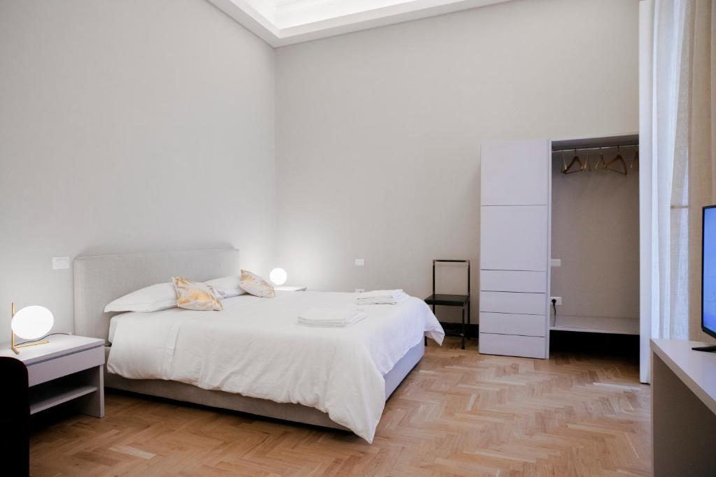 Postel nebo postele na pokoji v ubytování Teatro Suites Rooms