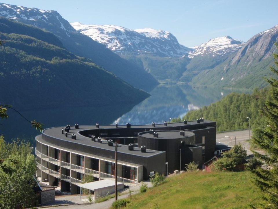 a building with a view of a valley with mountains at Hordatun Hotel in Røldal