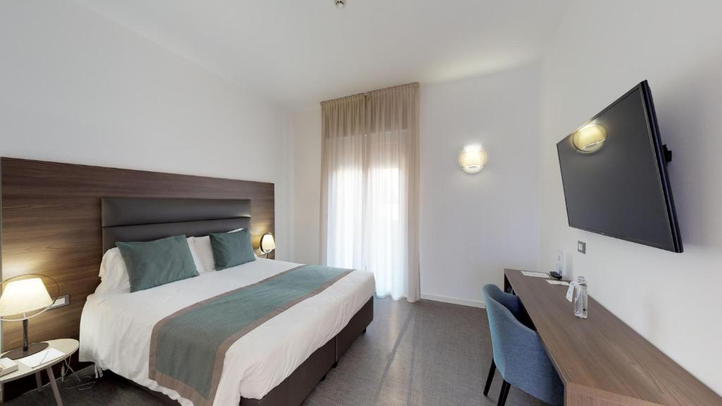 Postel nebo postele na pokoji v ubytování Hotel Villa Sorriso