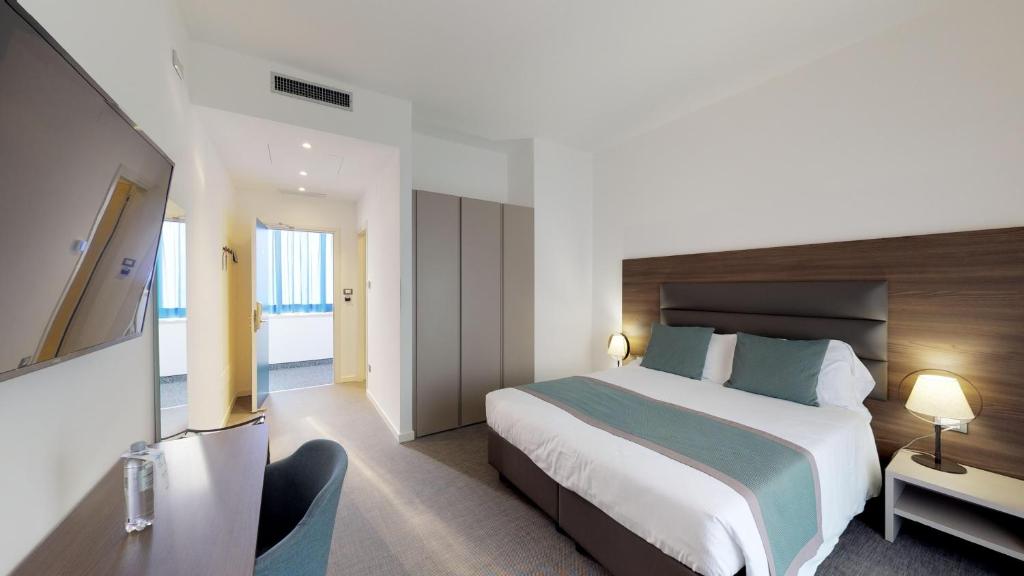 Postel nebo postele na pokoji v ubytování Hotel Villa Sorriso