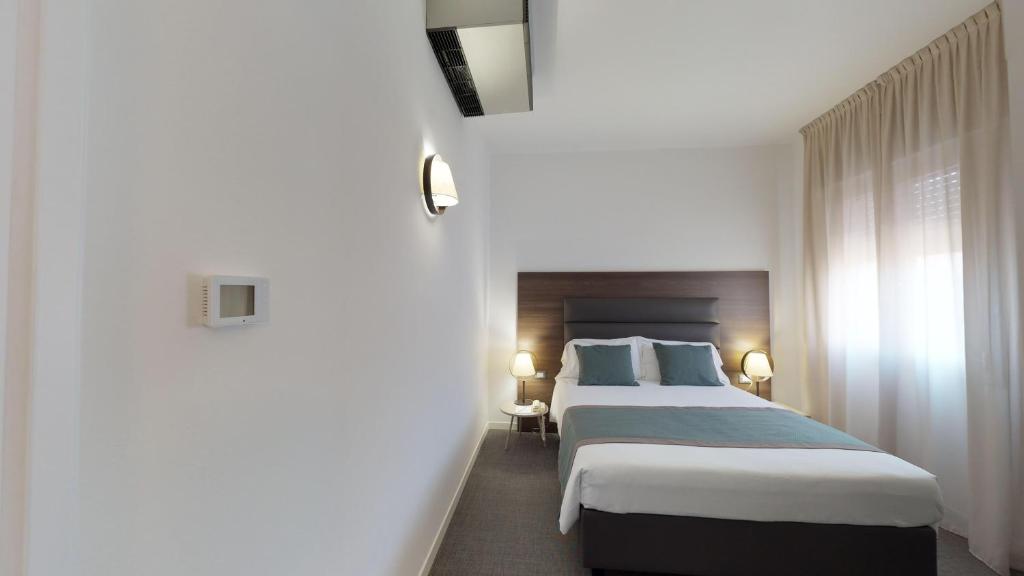 Postel nebo postele na pokoji v ubytování Hotel Villa Sorriso
