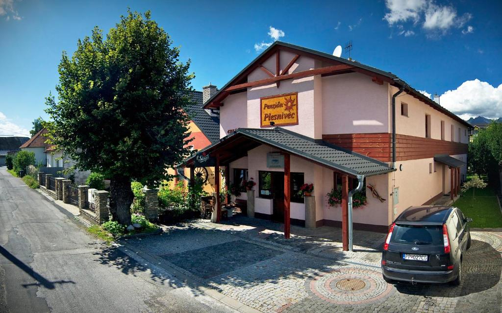 a car parked in front of a building at Penzion Plesnivec in Poprad