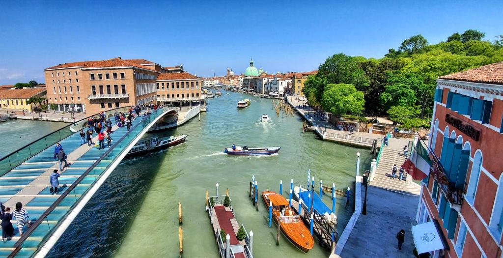 a view of a river with boats and buildings at Hotel Santa Chiara in Venice