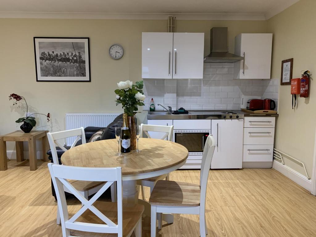 a kitchen and dining room with a table and chairs at Southernwood - Studio 1 in Didcot