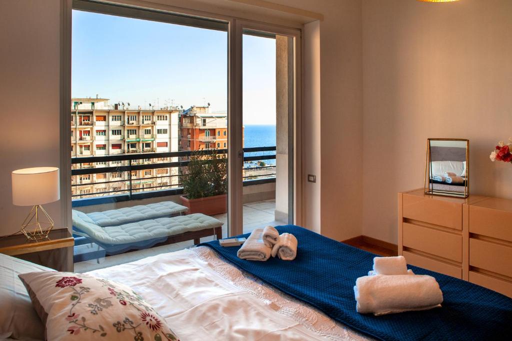 a bedroom with a bed and a large window at Mareluna Penthouse - Luxury Suites & Rooftop in Salerno