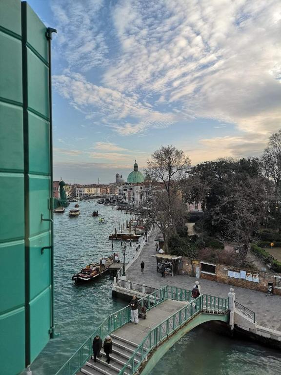 a view of a river with a bridge and boats at Hotel Santa Chiara in Venice
