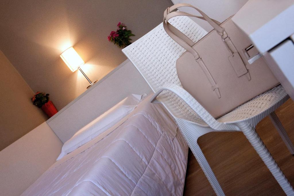 Postel nebo postele na pokoji v ubytování Hotel Mennini