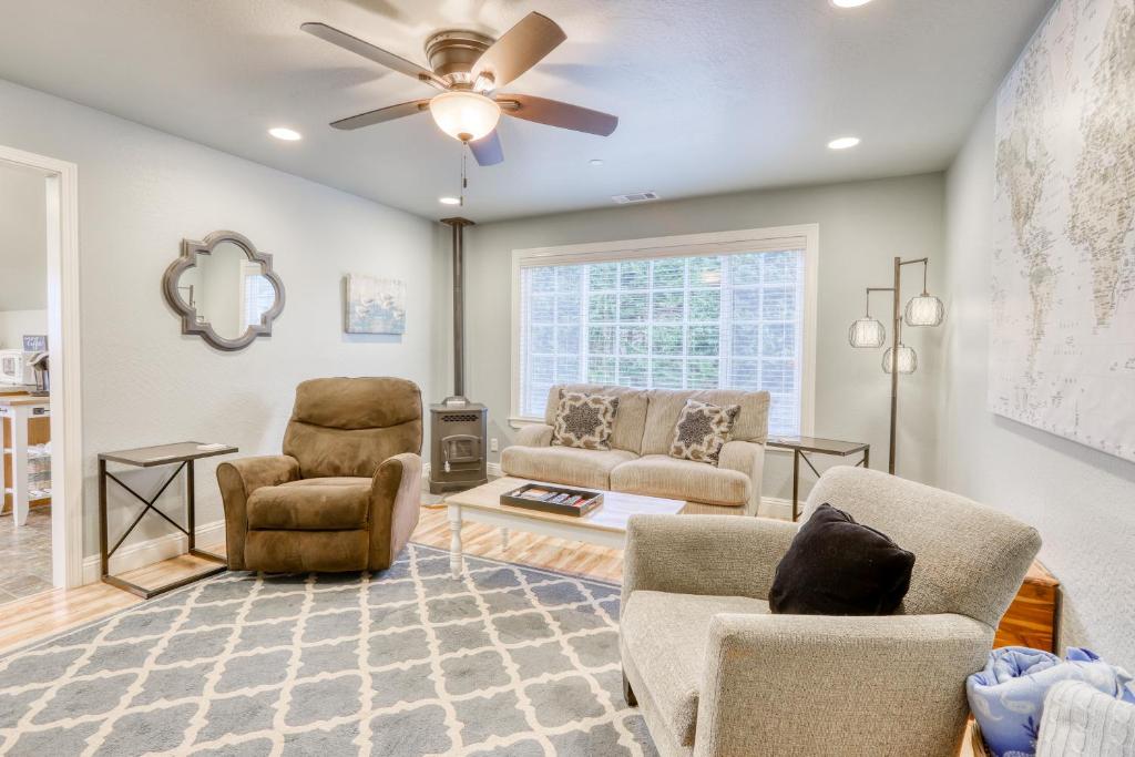 a living room with chairs and a ceiling fan at Azalea Haven in McKinleyville