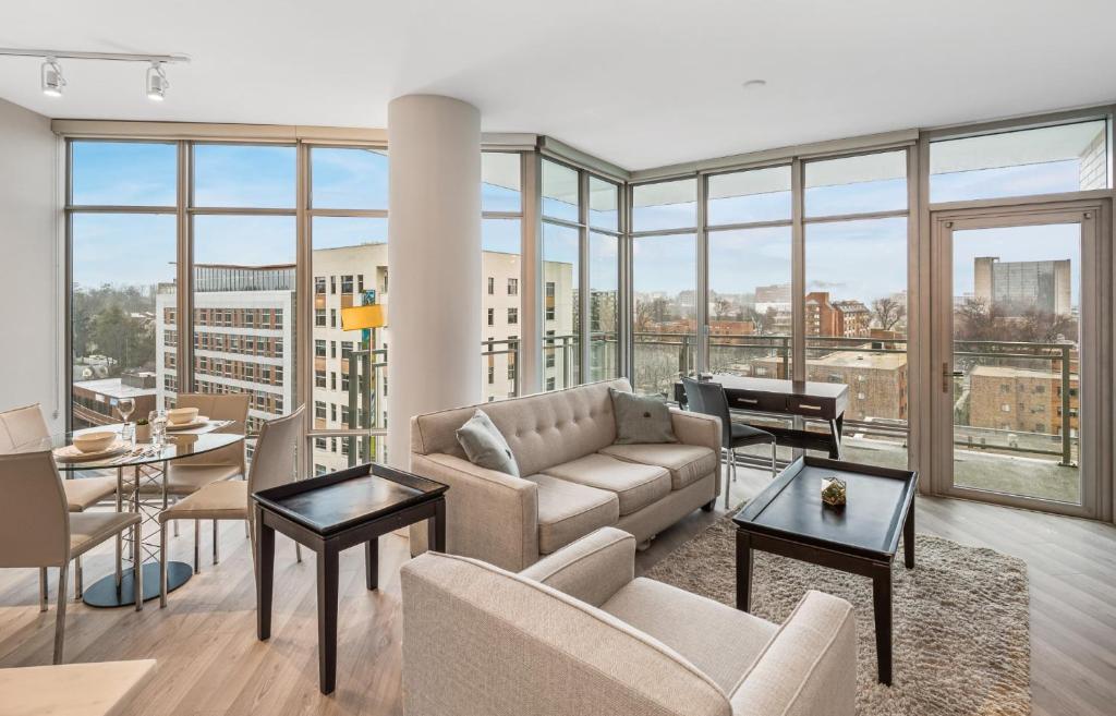 a living room with a couch and a table at Bluebird Suites Near Chevy Chase in Bethesda