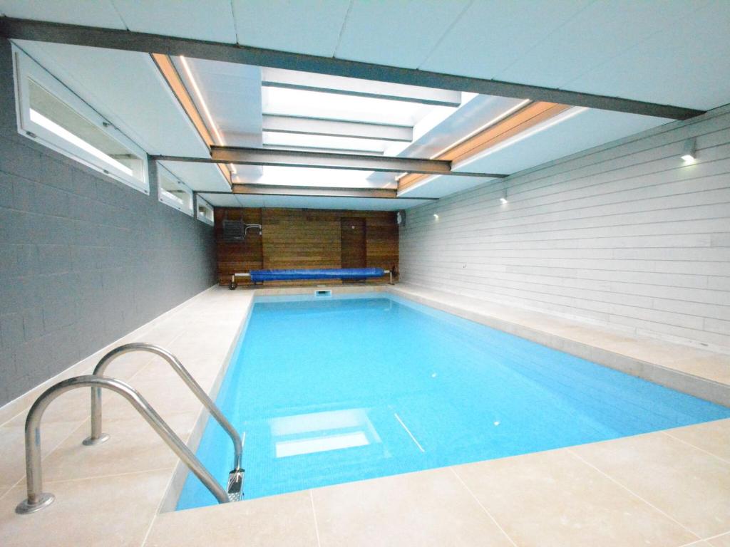 a large swimming pool in a building with a ceiling at Detached holiday home in Goesnes with private pool in Goesnes