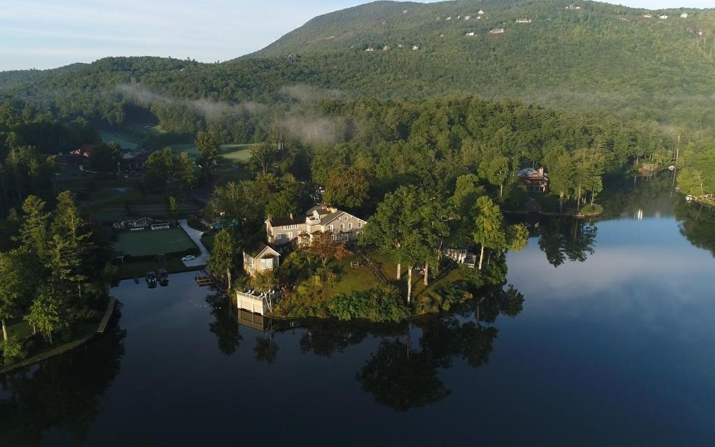 an aerial view of a house on an island in a lake at The Greystone Inn in Lake Toxaway