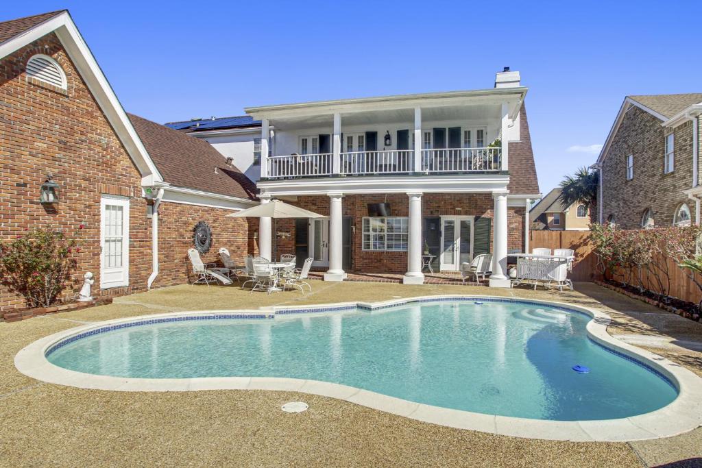 a swimming pool in front of a house at Lovely Home Only 15mins from Downtown NOLA in New Orleans